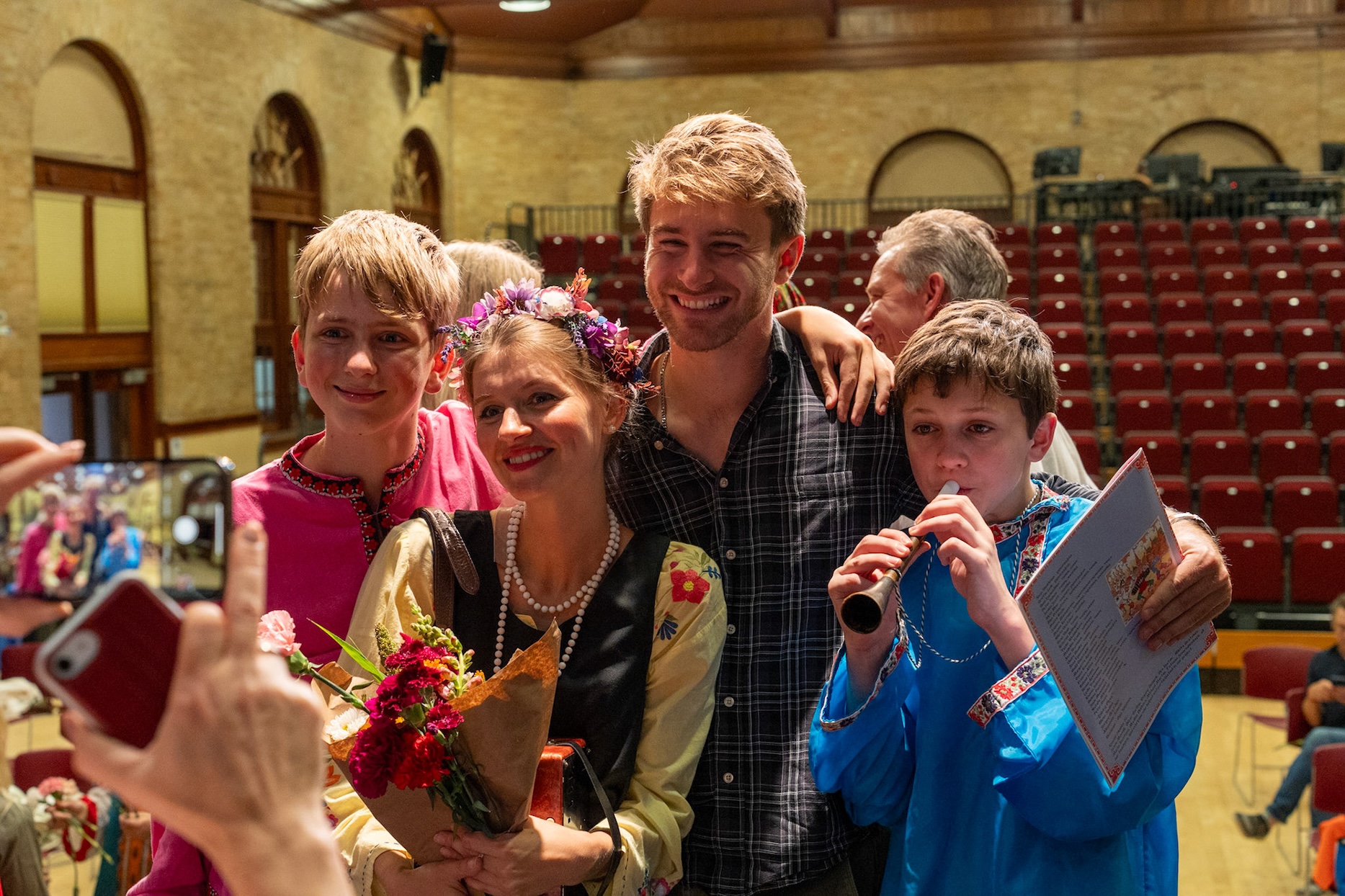 actress poses with fans after a play. 
