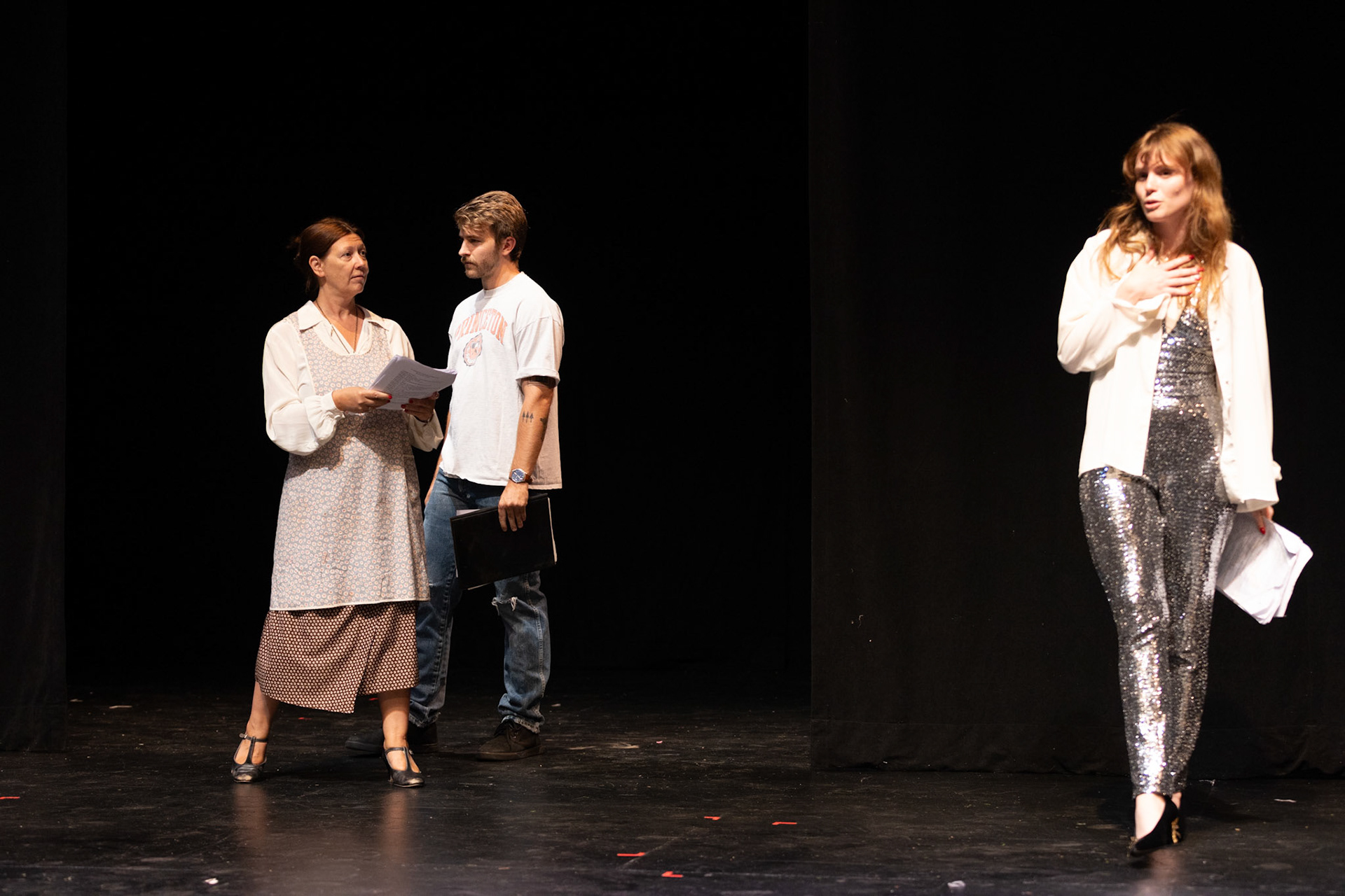 Students perform in a play onstage. 