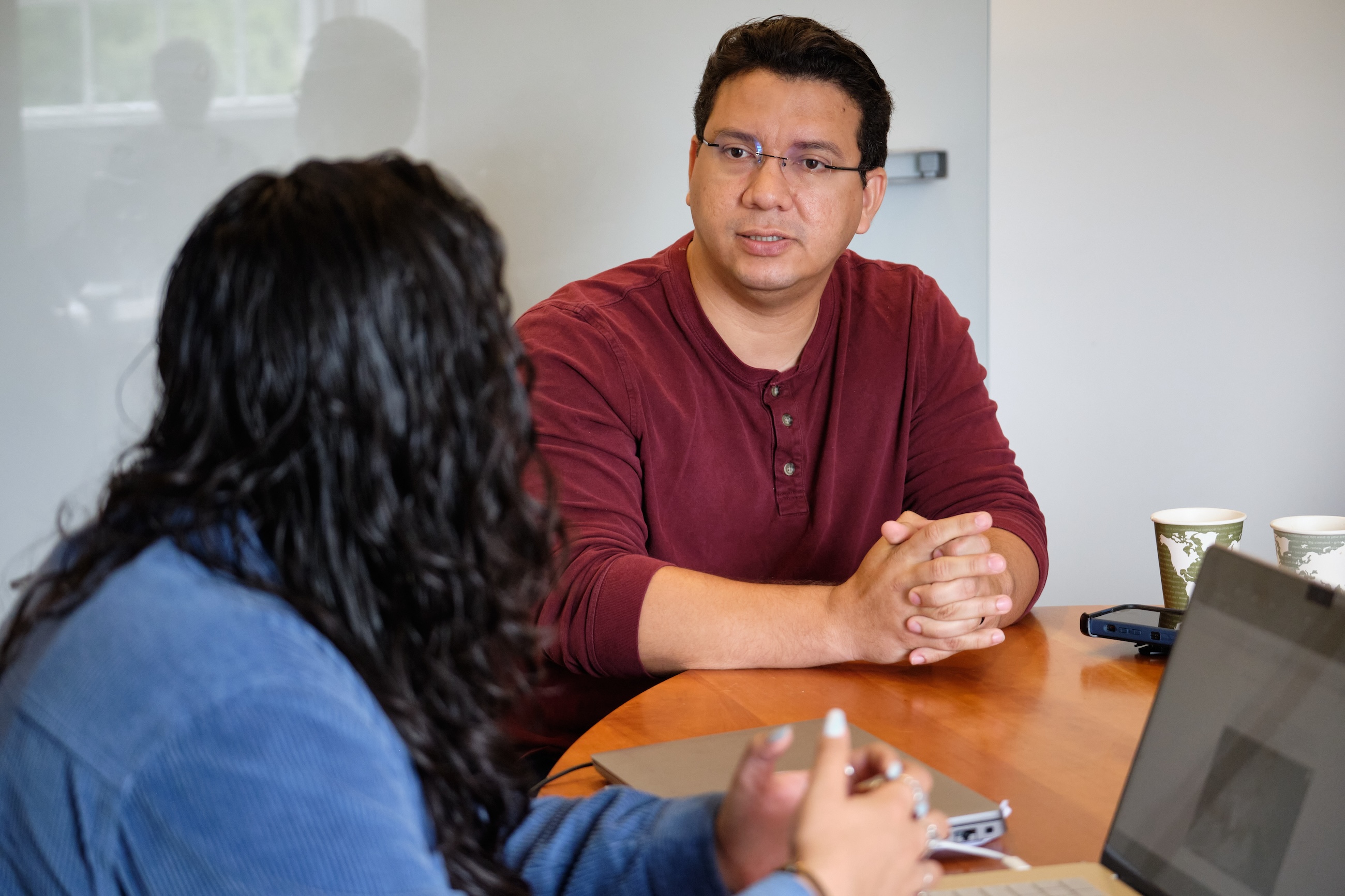 Two students talk in Portuguese class. 