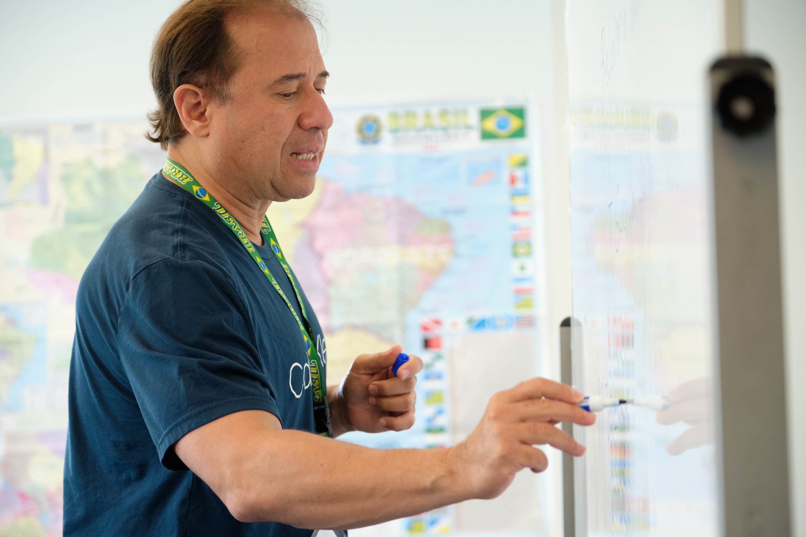 A teacher writes on the whiteboard in class.