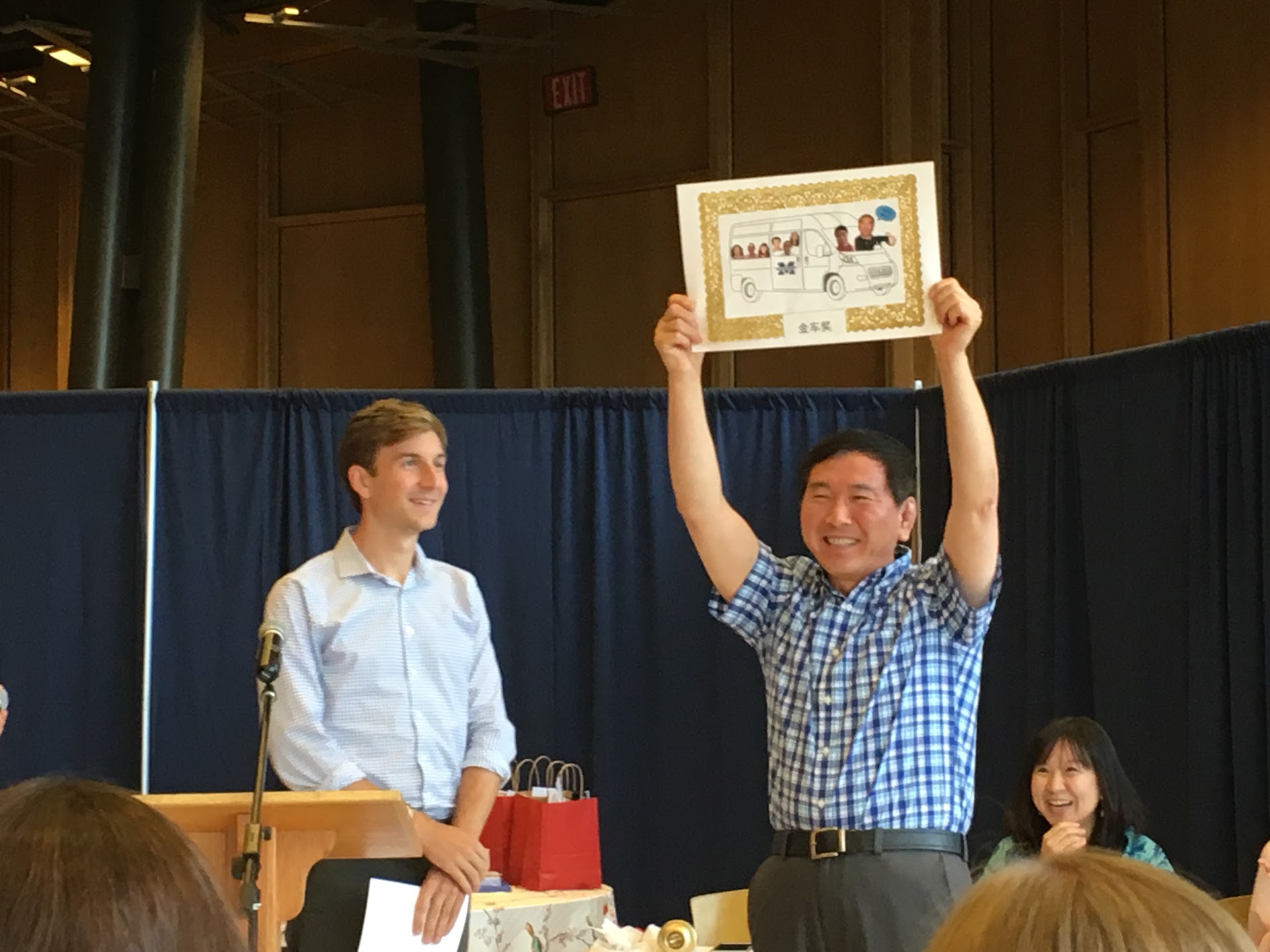 A man receiving an award at the Chinese School at Middlebury College. 