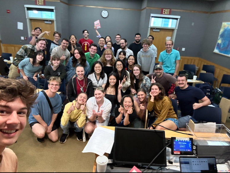 a group of students smiles at the camera. 