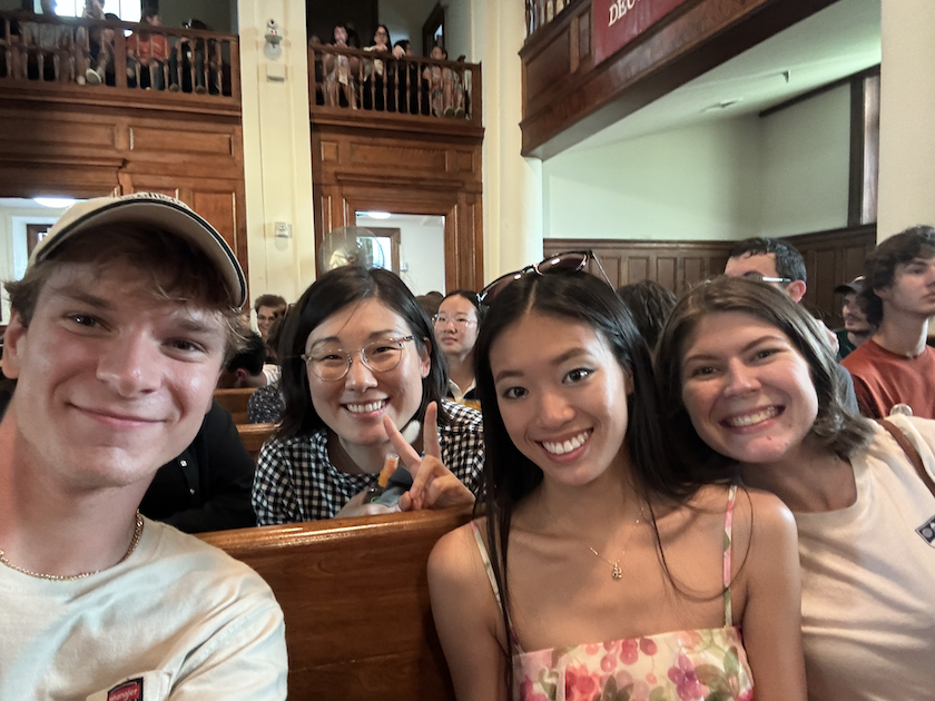 Chinese School students smile at the opening ceremony in the chapel. 