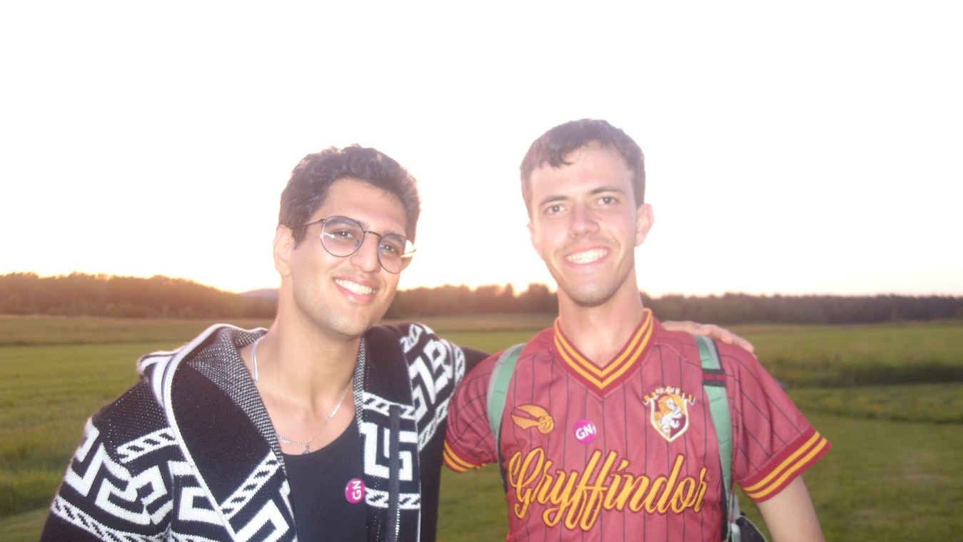 Two men smile at the camera. 