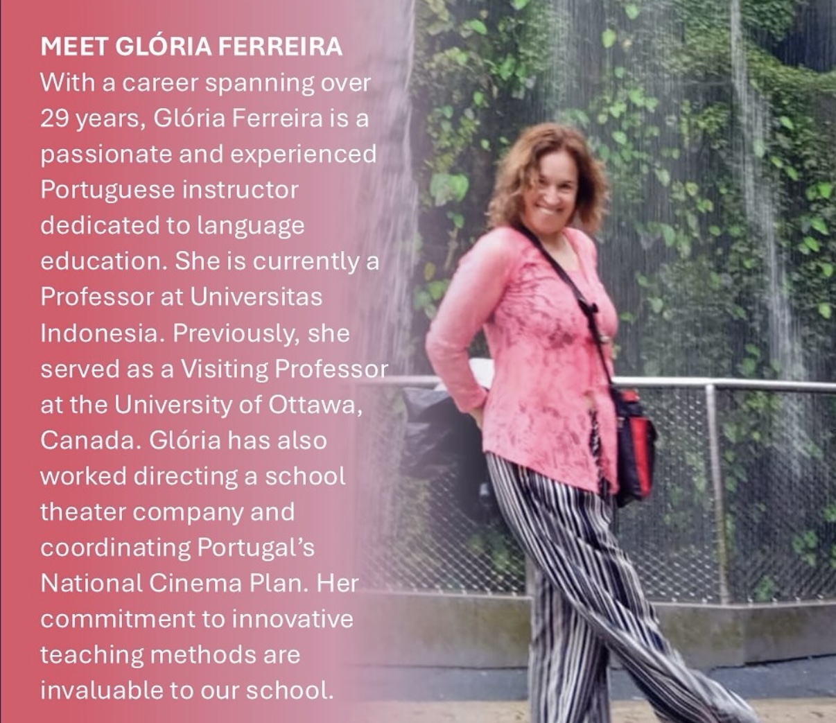 A woman in a pink shirt smiles at the camera. 