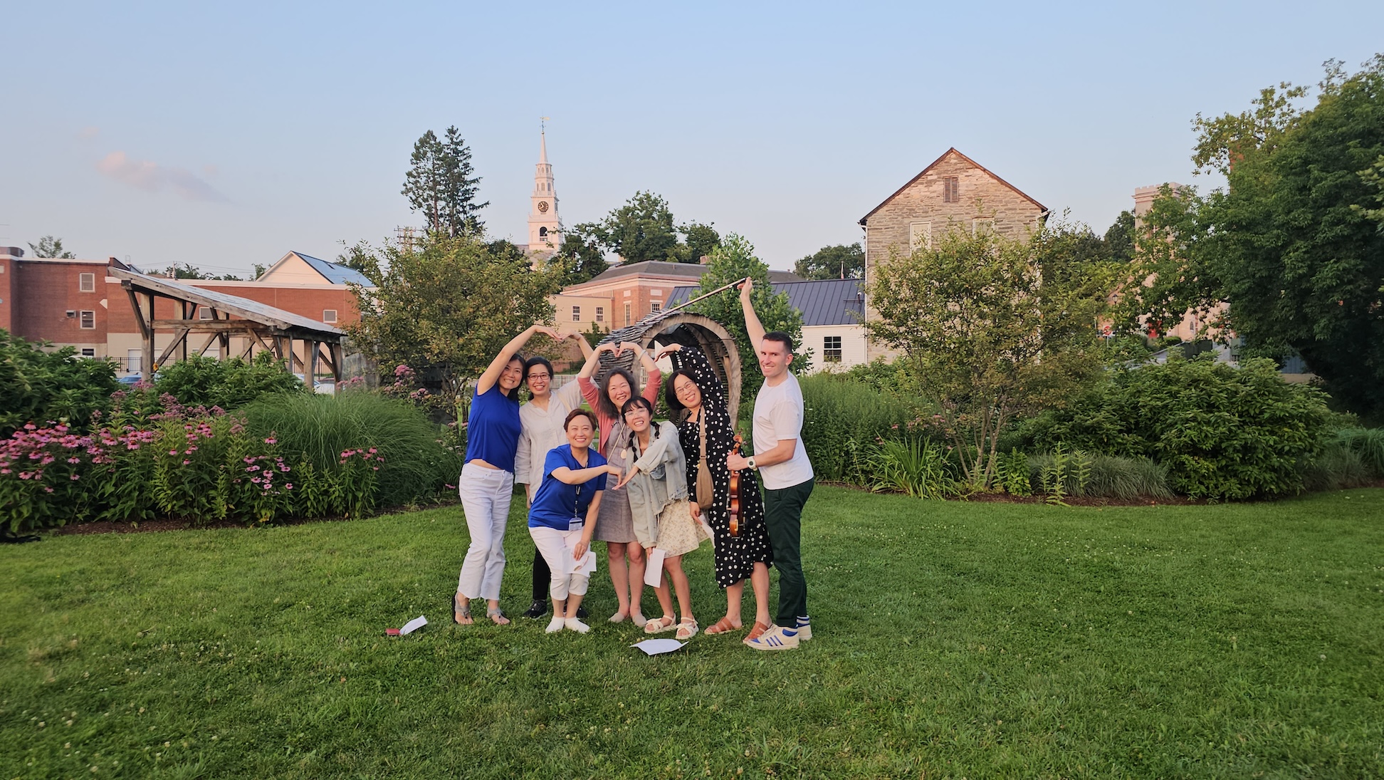 A group of teachers and graduate students spends some time outside.