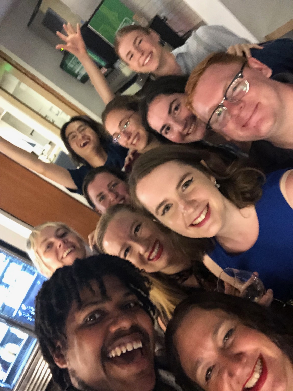 A group of staff members smile together at the Italian School.