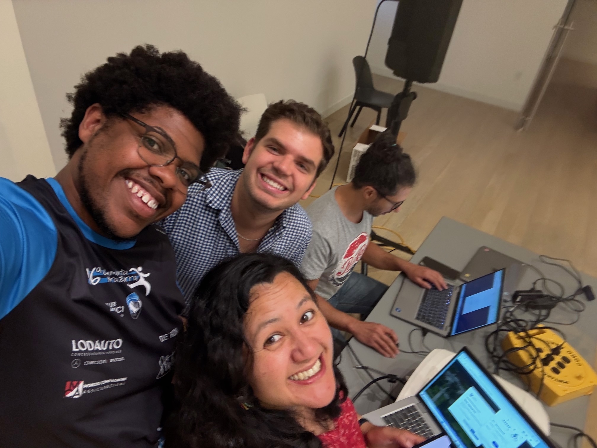 Three friends work on their computers together
