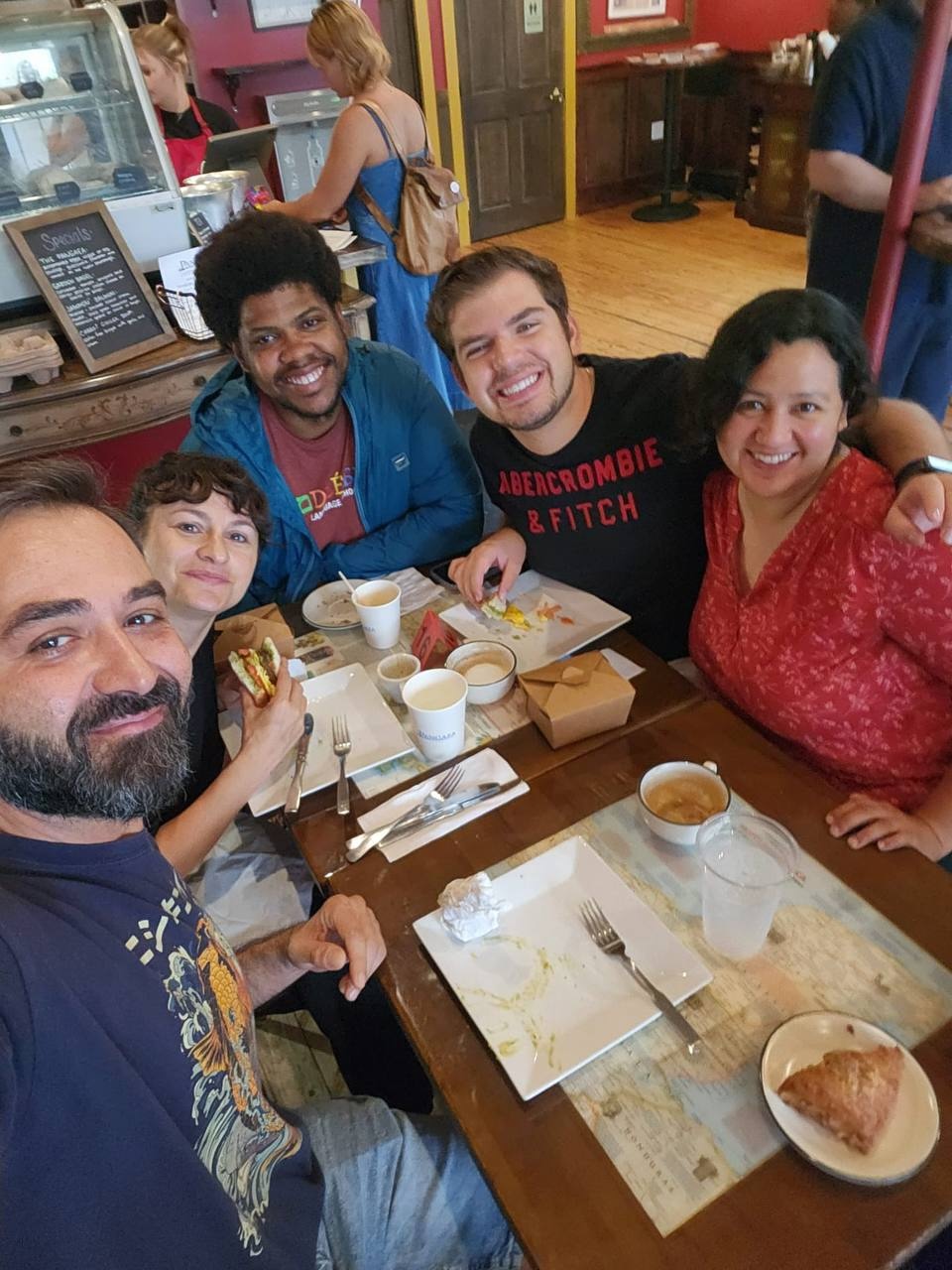 Friends eat breakfast at a restaurant. 