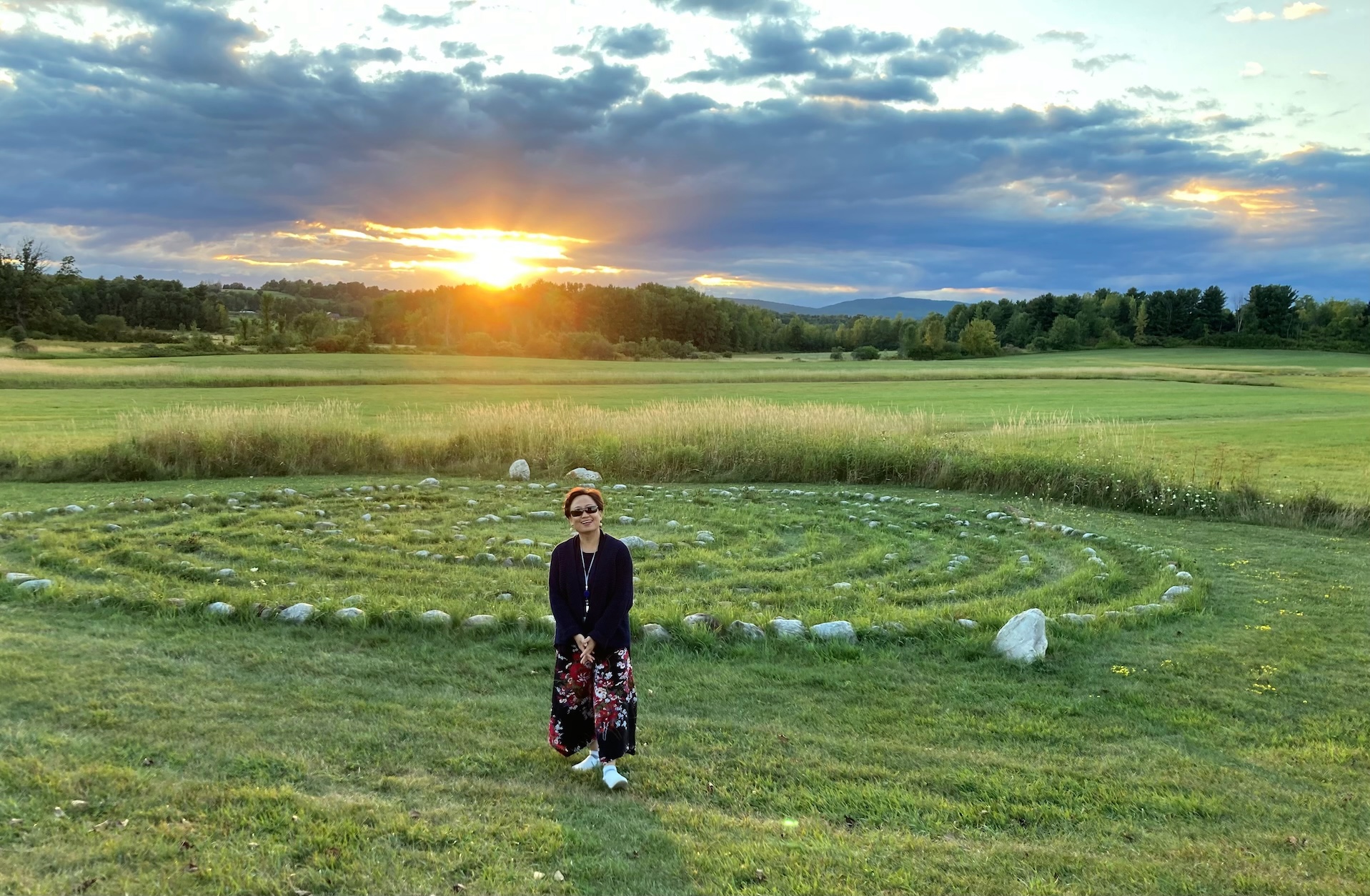 A woman in a field at sunset. 