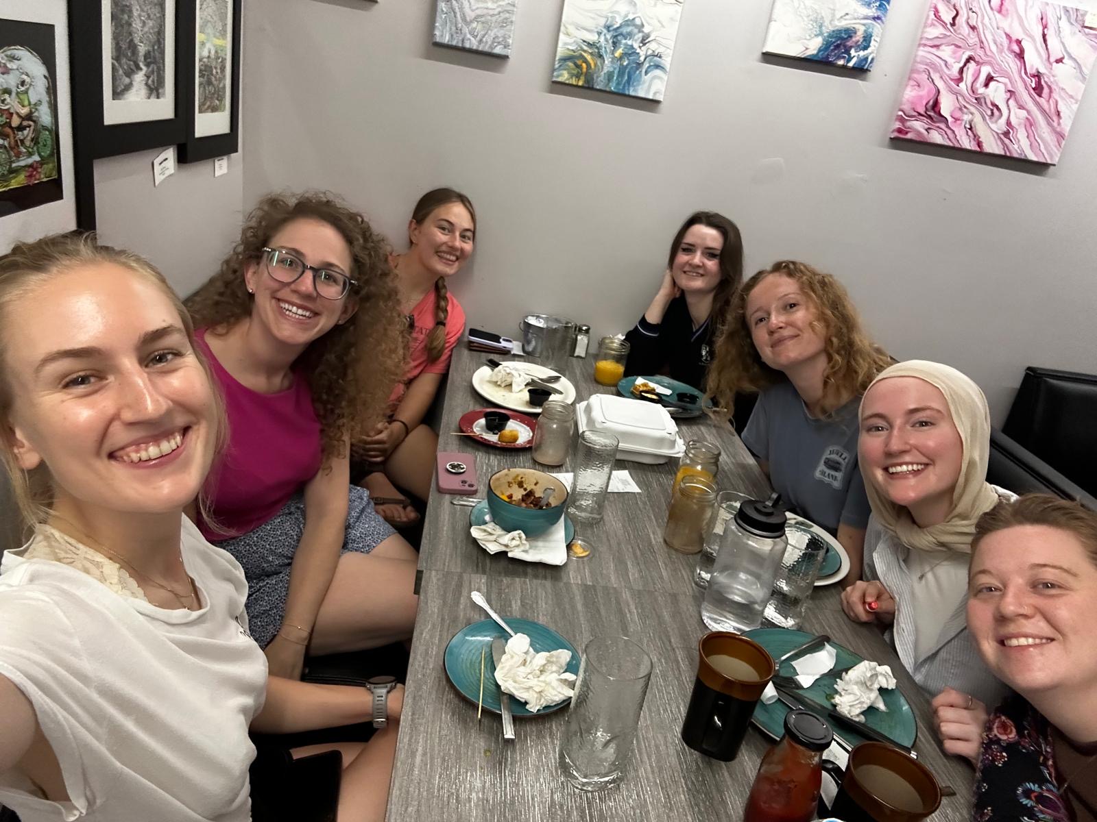 A group of students eat at a restaurant. 