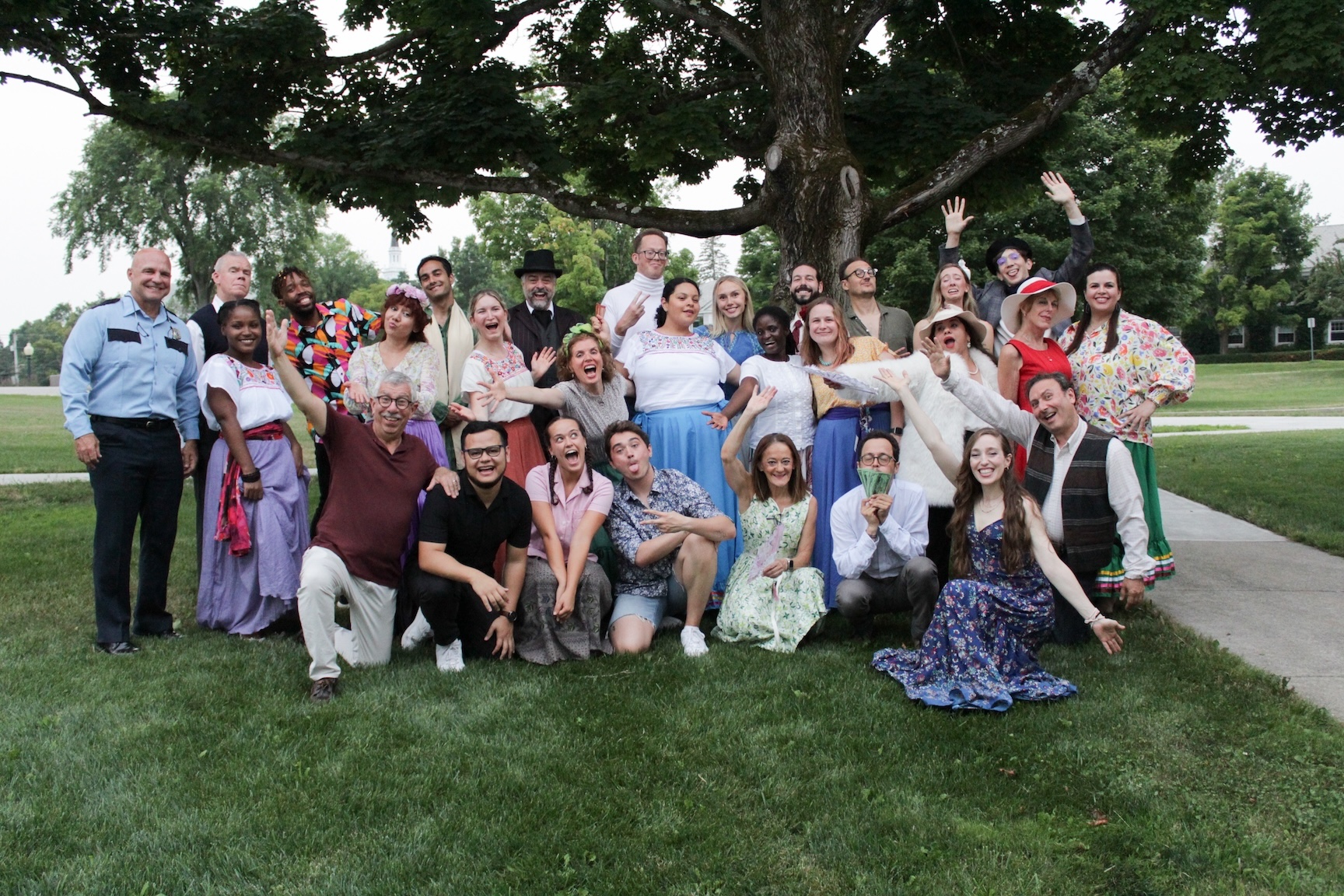 a group of students smiles on the lawn