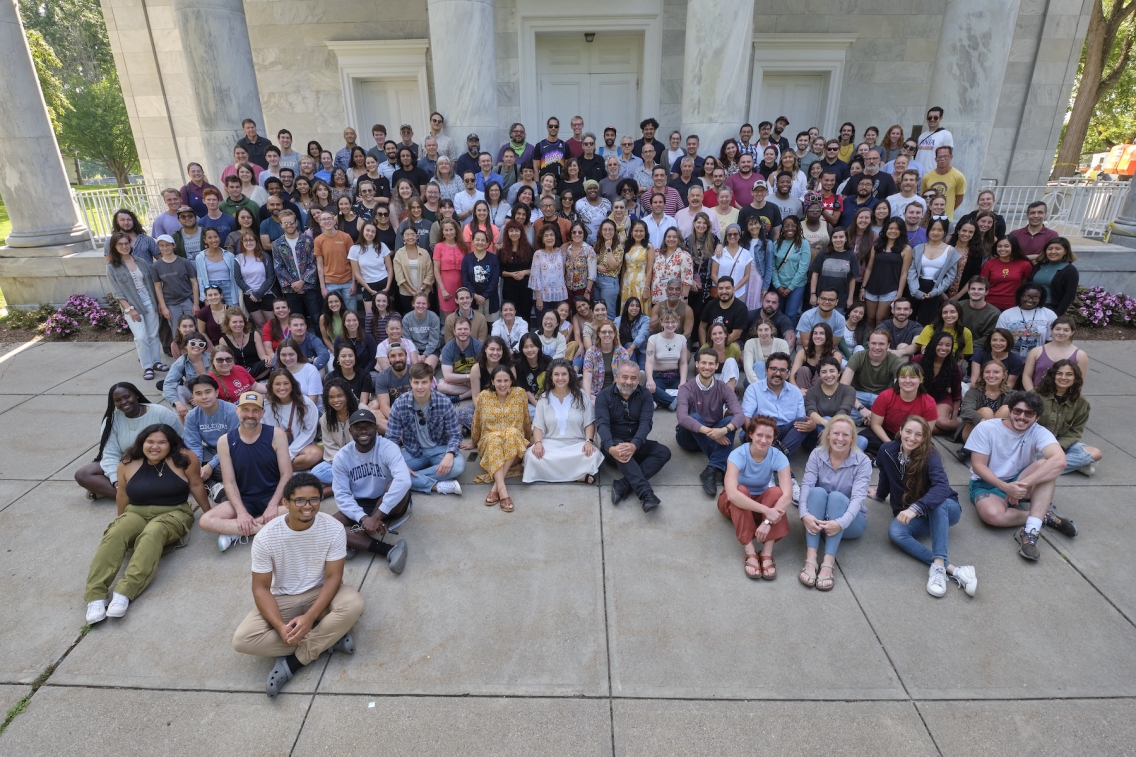 Students sit together on the chapel steps. 