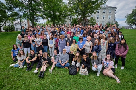The German School 2023 stands in the grass on the Middlebury College campus. 