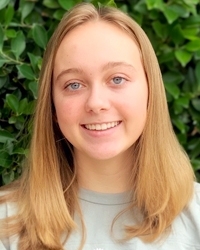 A woman smiles at the camera.