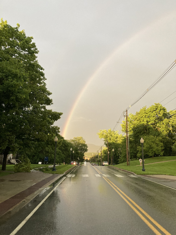 A rainbow over a street.