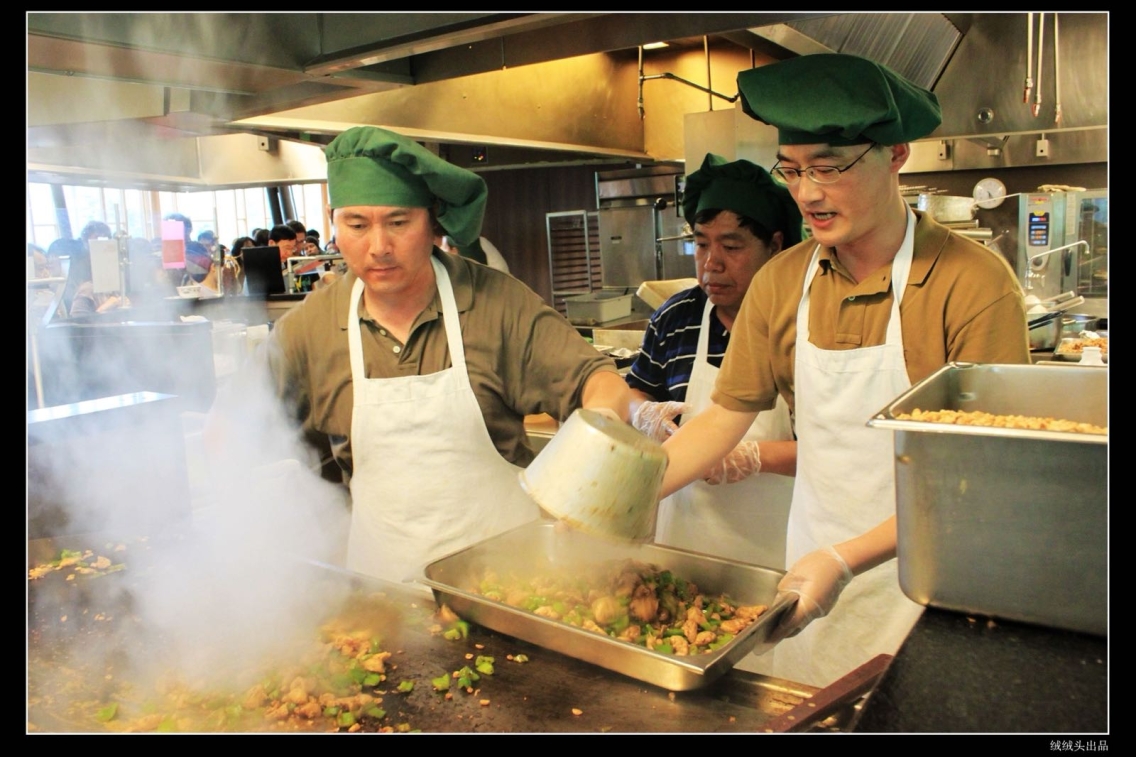 Coworkers cook a huge Chinese meal together.