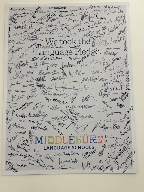 A sign with signatures on it reading "We took the Language Pledge"