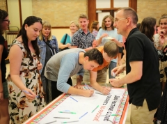 Students sign the language pledge with Program Director.