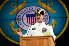 A retiring Coast Guard captain presents at an event. 