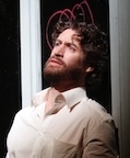 An opera singer looks off into the distance.