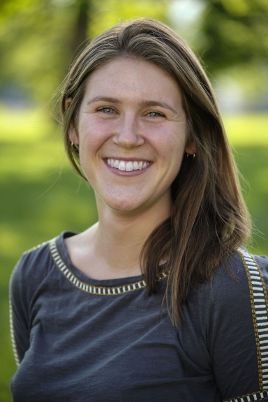 Woman with brown hair smiling at the camera 