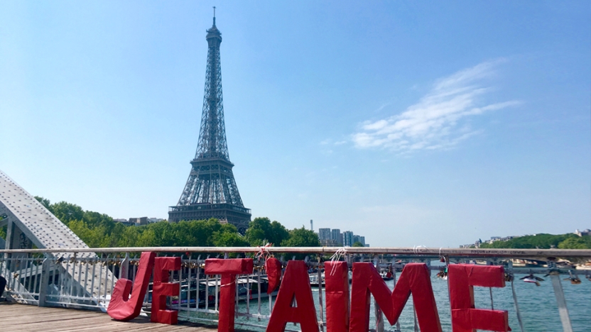 The Eiffel tower with blue sky in background.