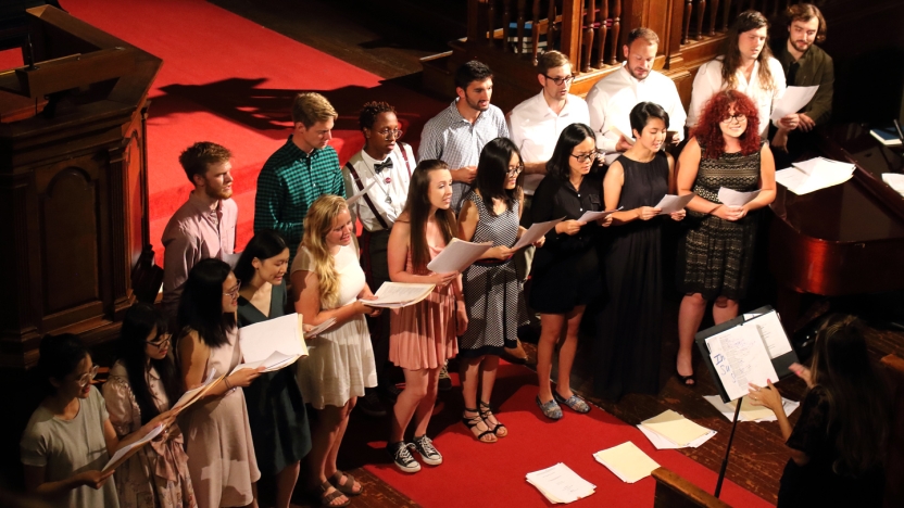 Large group of male and female German School students sing in a choir.