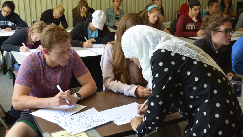 Students learning Arabic lettering.