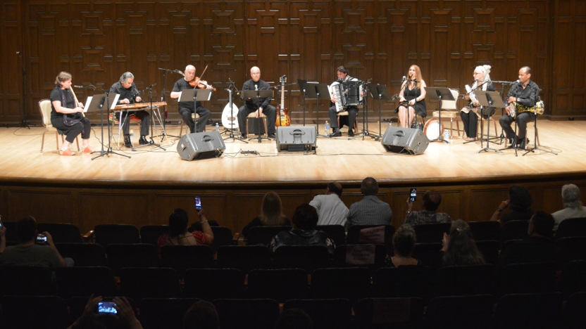 Arabic students performing a musical piece on stage.