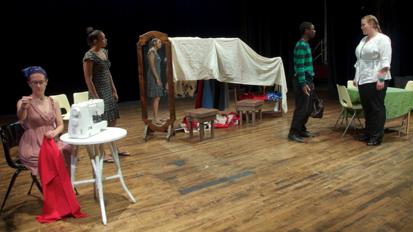 Four spanish language school students acting in a play.