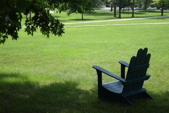 View of campus lawn with Adirondack chair on it.