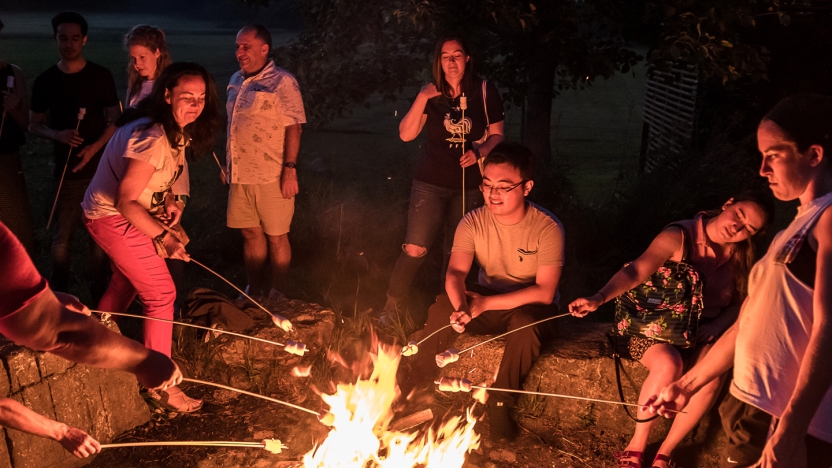 French Language Schools students roasting marshmallows