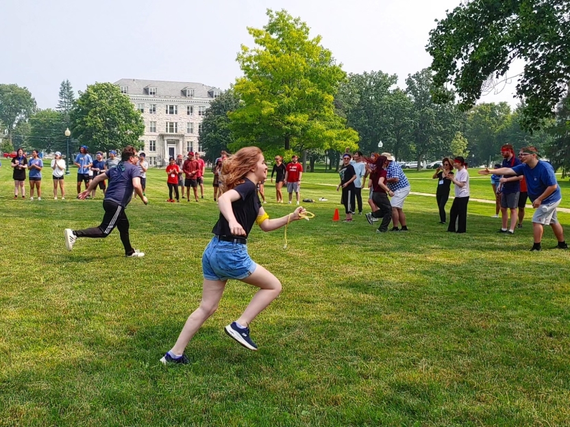 A student runs, playing a game outside.