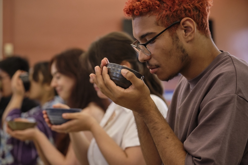 Students drink tea in a row. 