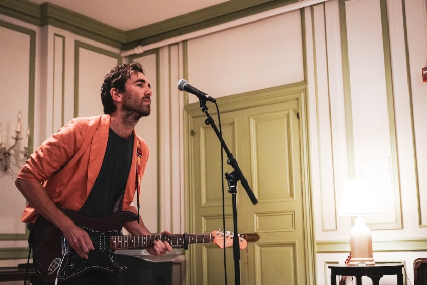 A man plays electric guitar. 