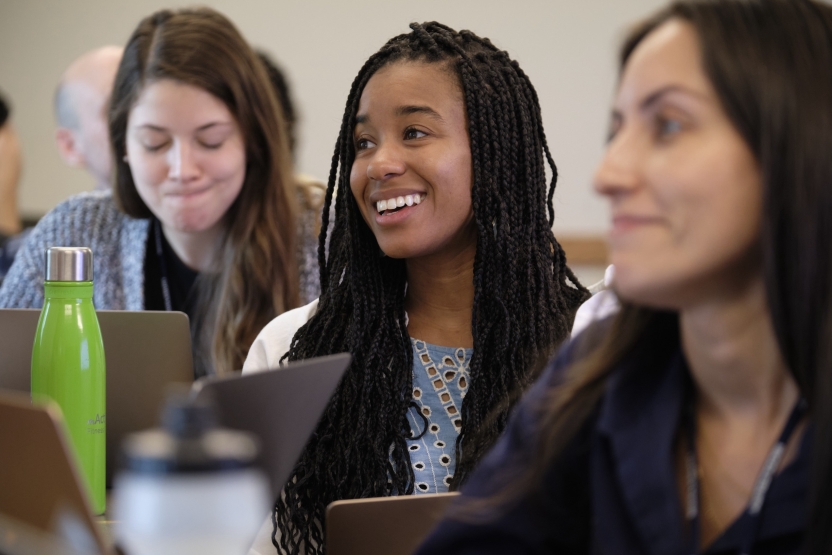 A student smiles as she sits in class.