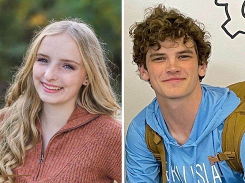 Two students smile at the camera. 