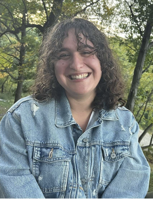 A student smiles at the camera.