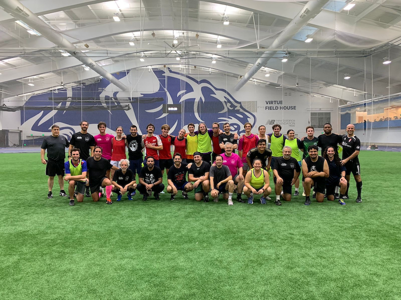 Students and professors pose after a soccer game. 