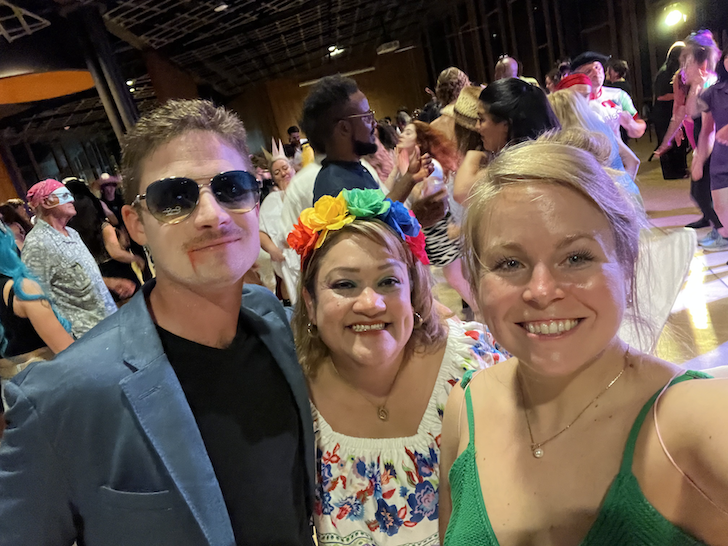 Two women and a man at a costume party. 