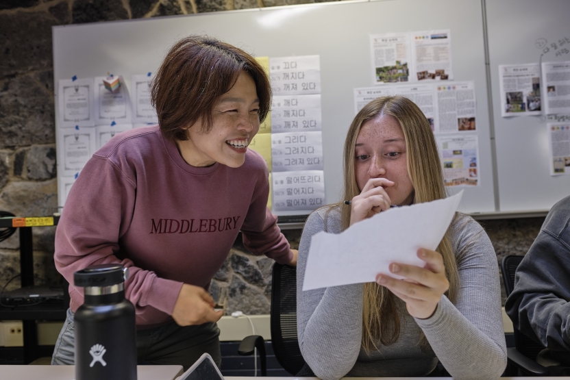 A teacher reads over her student's work