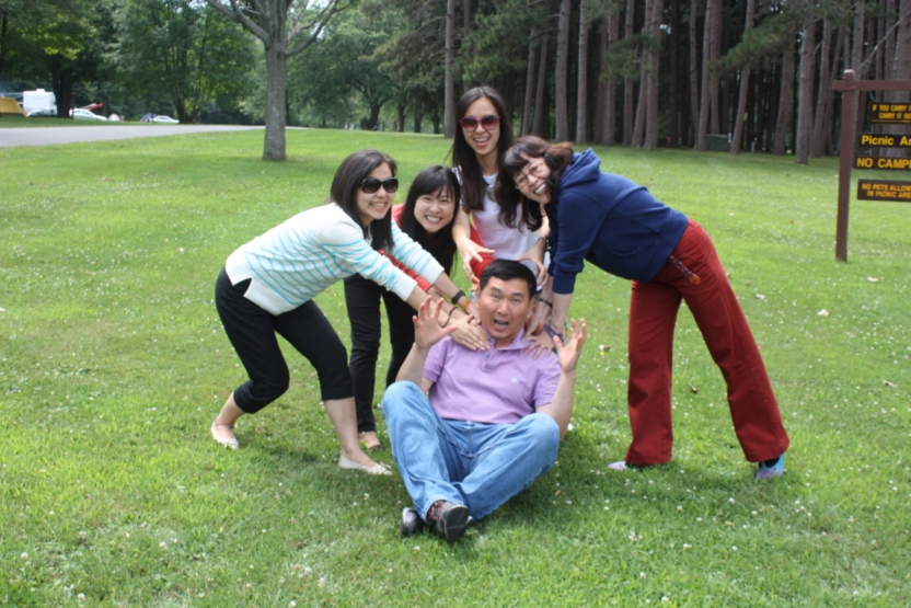 A man pretends to be scared as colleagues push him down. 