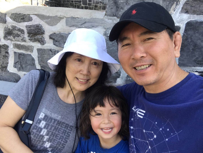 A father and mother with their child. 