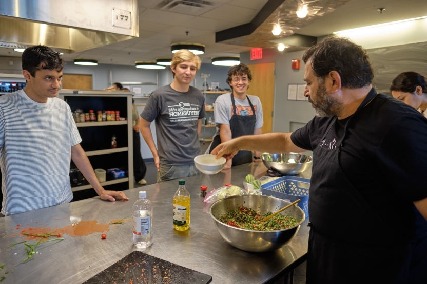 Students learn to cook Arabic food with their teacher. 