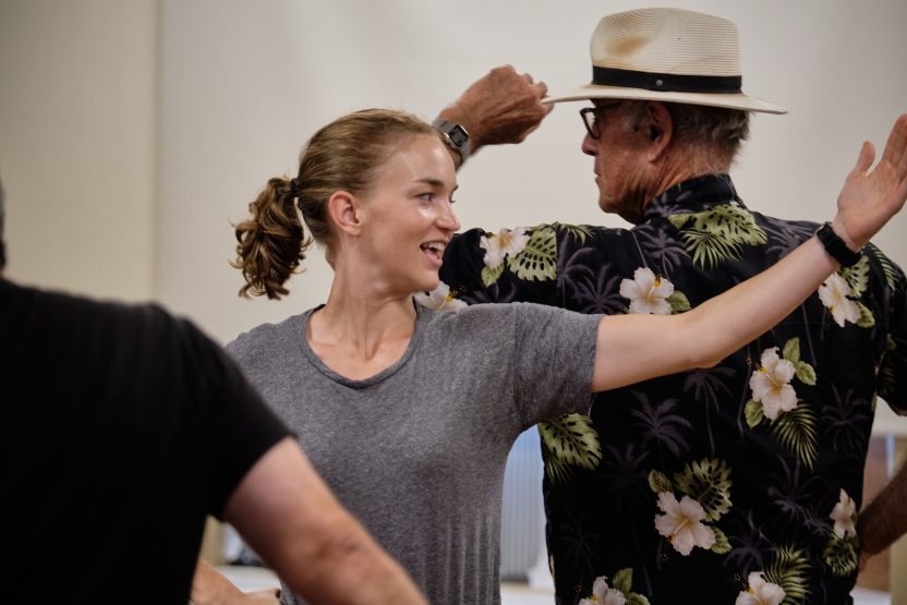 A younger person and an older person dance. 