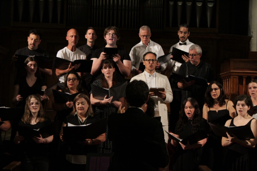 A mixed choir sings in concert. 