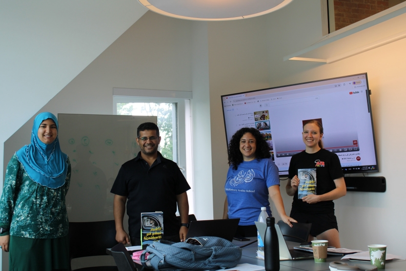 Students present at the front of the classroom. 