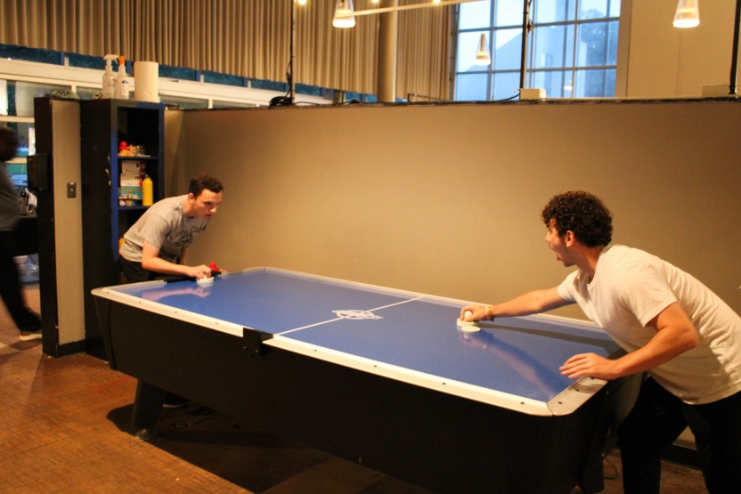 Students play ping pong. 