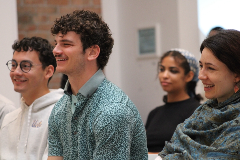 Students smile as they sit in class. 